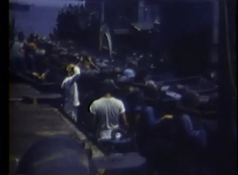 PACIFIC OCEAN - 1945: Off-duty aboard — sailors lounge along the deck catwalk 库存影片 343119735