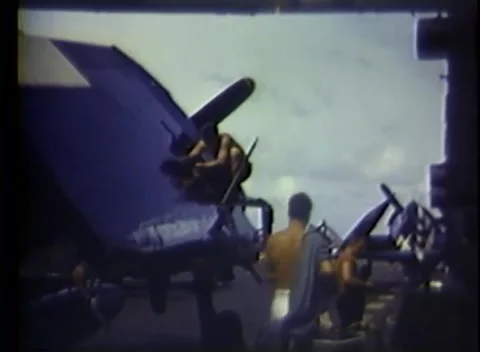 PACIFIC OCEAN - 1945: Folded wings — crewmen stand beside raised wings Video stock 343119755
