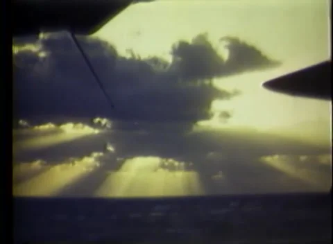 PACIFIC OCEAN - 1945: Ocean sky — sun rays fan through heavy clouds 库存影片 343119731