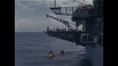 PACIFIC OCEAN - 1966 - A deck of the USS Hornet is lowered to bring the AS-202 Video stock 316613659