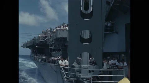 PACIFIC OCEAN - 1966 - US Navy sailors are lined up on the deck of the USS Video stock 313049126