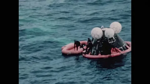 PACIFIC OCEAN - 1970 - The Apollo 13 command module is towed to the USS Iwo Jima Stockbeeldmateriaal 304157701