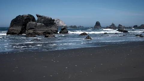 Pacific Ocean Beach with Rocks and Waves Crashing in Slow Motion Video stock 87274498