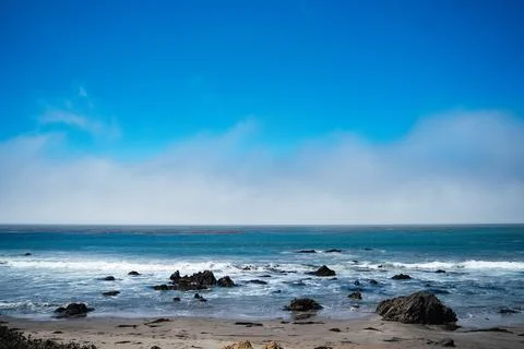 Pacific ocean beach with rocks Stock Photos