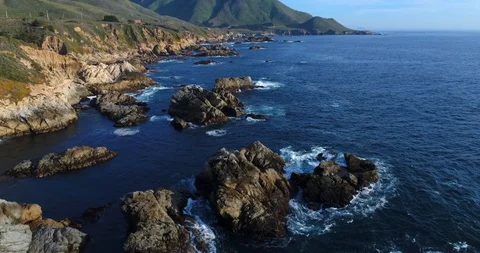 Pacific Ocean Rocky drone shot flying over and revealing mountain Stock Footage 129922853