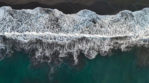 Pacific Ocean Waves Creating White Foam Patterns on Black Sand Beach Stock Photos