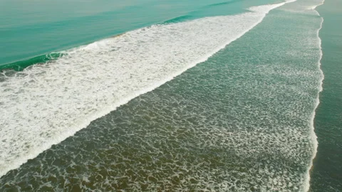 Pacific Ocean waves rolling to sandy shore viewed from above Stock Footage 344775454