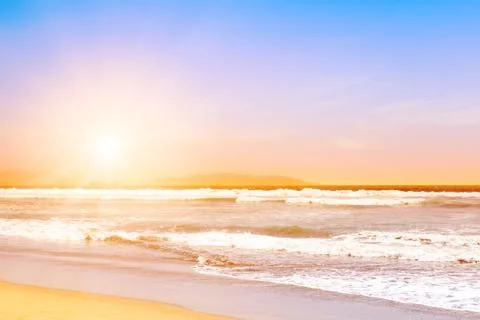 Pacific ocean waves at sunset Stock Photos