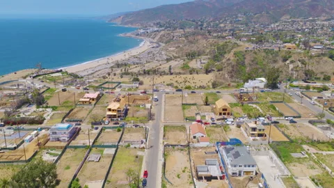 Pacific Palisades Coastal Aerial Pullback View of Rebuilding Homes and Beach 01 Stock Footage 334581759