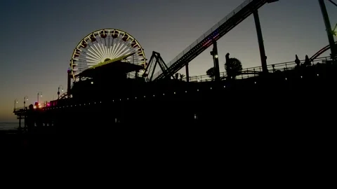 Pacific Park after sunset slow motion with police cruiser driving on pier Stock Footage