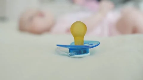 Pacifier with Newborn Baby in Background, Concet of Restless Kid Stock Footage 196886111