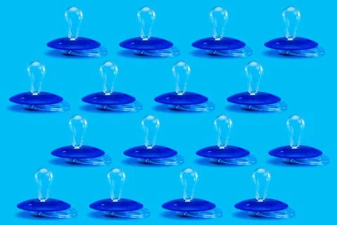 Pacifier pattern plastic soother isolated on blue background. Stock Photos