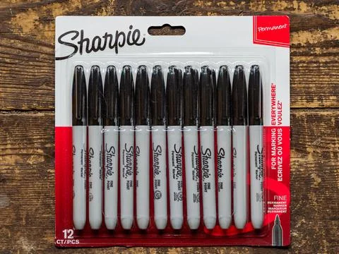 Pack of 12 Sharpie permanent markers on a wooden surface. Stock Photos