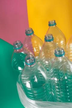 A pack of 7 empty and recyclable plastic water bottles, with no caps, blue se Stock Photos
