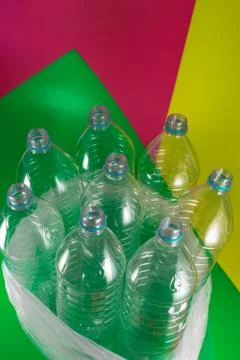 A pack of 8 empty and recyclable plastic water bottles, with no caps, blue se Stock Photos