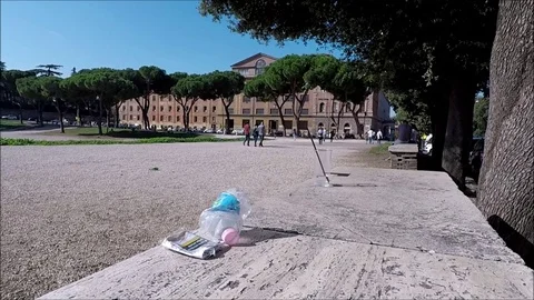 Pack of cigarettes bottle and plastic cup abandoned on a wall Stock Footage 118835016
