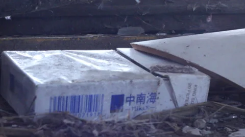 Pack of cigarettes lying on the floor of old factory Stock Footage 36933873