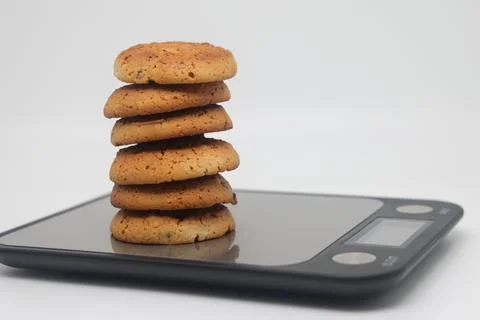 A pack of cookies on an electronic kitchen scale, accurate calorie counting,  Stock Photos
