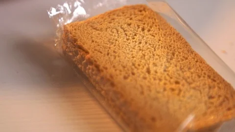 Pack of crisp bread  on white kitchen table in slow motion Stockbeeldmateriaal 120876739