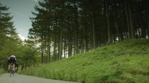 PACK OF CYCLISTS RIDING AWAY FROM CAMERA - SLOWMO 02 Stock Footage 141280061