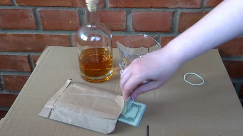 A pack of dollars and whiskey Stock Footage 95594882