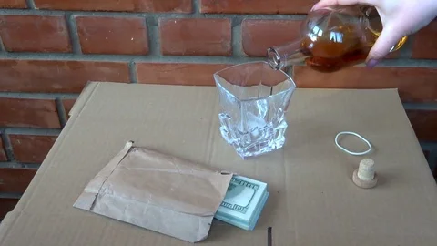 A pack of dollars and whiskey Stock Footage 95594905