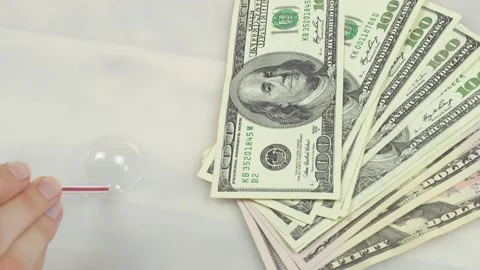 A pack of dollars on the background of a soap bubble inflates Stock Footage 138213240