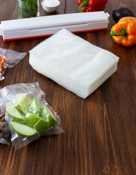 A pack of empty vacuum bags next to the vacuum cleaner Stock Photos