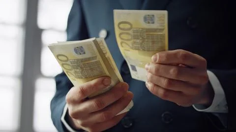 Pack euro bills counting by unknown business man closeup. Hands calculating cash Stock Photos