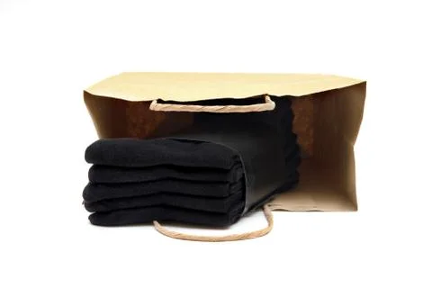 Pack of five black socks in a brown shopping bag isolated on white. 스톡 사진