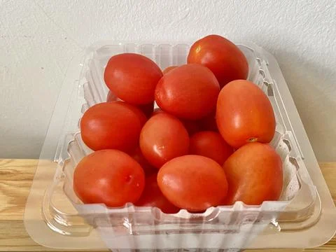 A pack of fresh cherry tomato in a plastic box Stock Photos