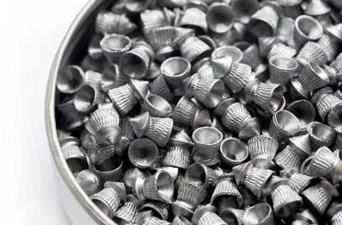 A pack full of sharp metal diabolo pellets, steel pellet air gun ammo, lots.. Stock Photos