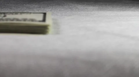 The pack of hundred-dollar notes moves on a table Stock Footage 50408694