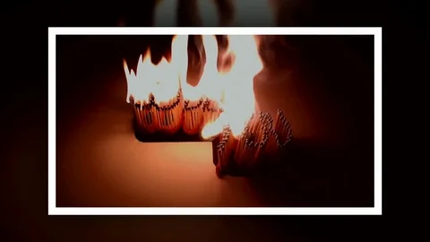 Pack of Man lights a match in darkness. Slow Motion Stock Footage 73541012