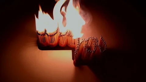 Pack of Man lights a match in darkness. Slow Motion Stock Footage 73543082