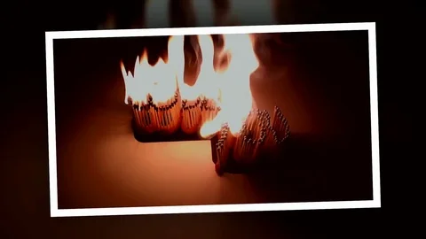 Pack of Man lights a match in darkness. Slow Motion Stock Footage 73546404