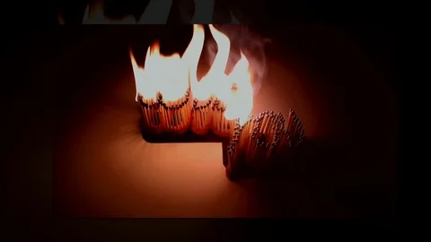 Pack of Man lights a match in darkness. Slow Motion Stock Footage 73548789