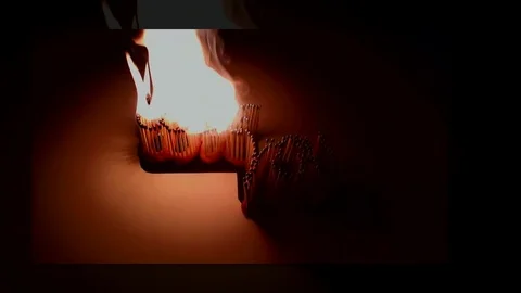 Pack of Man lights a match in darkness. Slow Motion Stock Footage 73549147