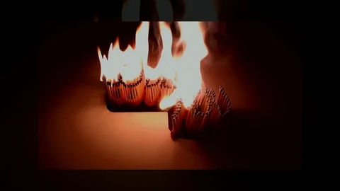 Pack of Man lights a match in darkness. Slow Motion Stock Footage 73549723