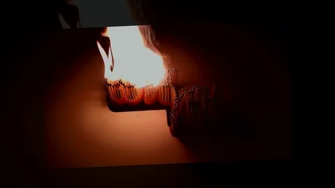 Pack of Man lights a match in darkness. Slow Motion Stock Footage 73551003