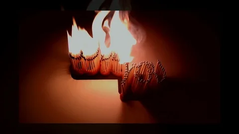 Pack of Man lights a match in darkness. Slow Motion Stock Footage 73551279