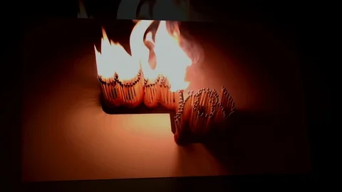 Pack of Man lights a match in darkness. Slow Motion Stock Footage 73551473