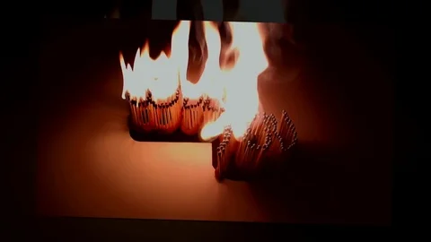 Pack of Man lights a match in darkness. Slow Motion Stock Footage 73551727