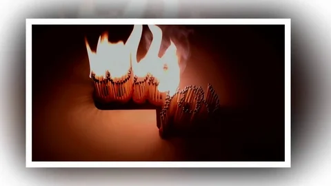 Pack of Man lights a match in darkness. Slow Motion Stock Footage 73552570