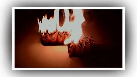 Pack of Man lights a match in darkness. Slow Motion Stock Footage 73554955