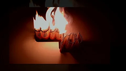 Pack of Man lights a match in darkness. Slow Motion Stock Footage 73557156