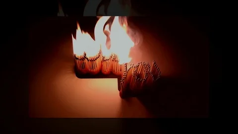 Pack of Man lights a match in darkness. Slow Motion Stock Footage 73558095