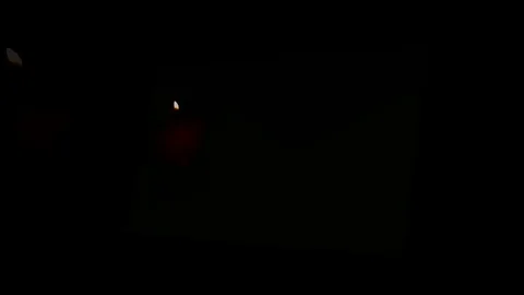 Pack of Man lights a match in darkness. Slow Motion Stock Footage 73559245