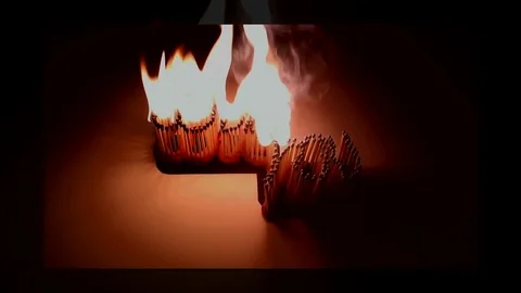 Pack of Man lights a match in darkness. Slow Motion Stock Footage 73560704