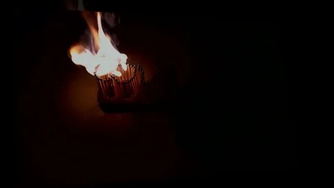 Pack of Man lights a match in darkness. Slow Motion Stock Footage 73560791